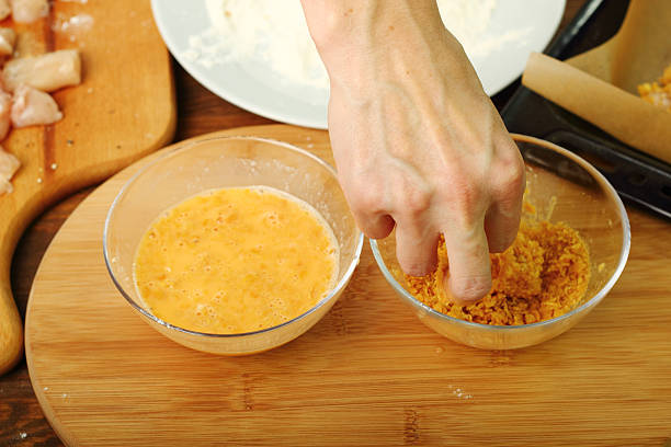 istock Roll floured, egged chicken fillet in corn flake crumbs 486374427