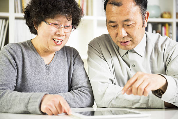 istock Asian senior couple using a tablet together 486374439