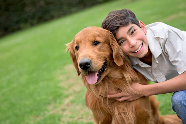 istock Happy boy with a beautiful dog at the park 486374892