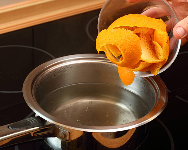 istock Add orange peel into saucepan with boiling syrup 486375081