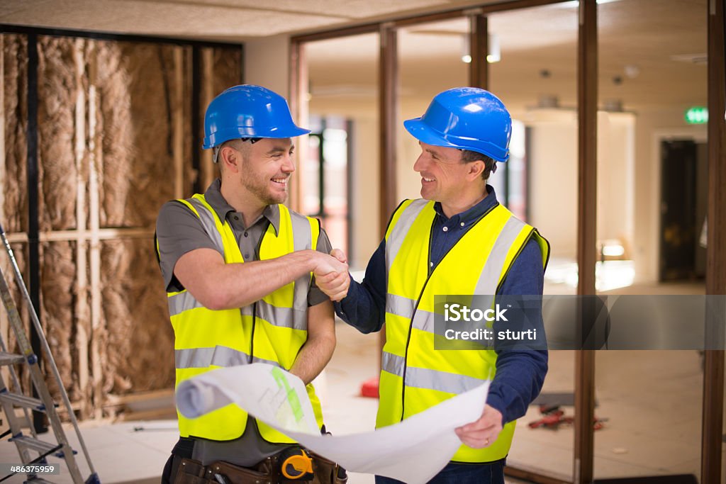 contractors agree deal contractors agree dealengineer stands in front of building steelwork DIY Stock Photo