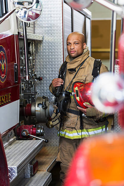 istock African American fire fighter standing next to truck 486376208