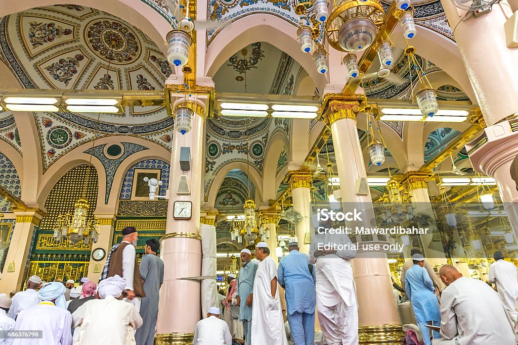 Nabawi mosque Medina, Saudi Arabia - March 7, 2015: Interior of Nabawi mosque. Nabawi Mosque is the second holiest mosque in Islam and here is Prophet Muhammad is laid to rest Mosque Stock Photo