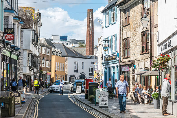 Tourists walk along Southside Street in the Barbican, Plymouth stock photo