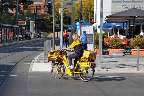 postwoman de livrer le courrier. - messenger deutsche post ag package germany photos et images de collection