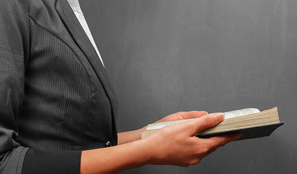 istock Teacher woman reads a book 486377021