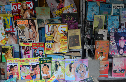 Woman observes books for sale among used second hand books