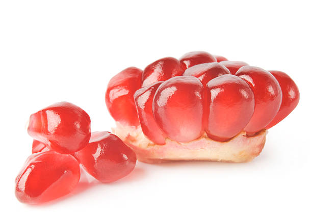 istock Ripe pomegranate piece isolated on white background 486377881