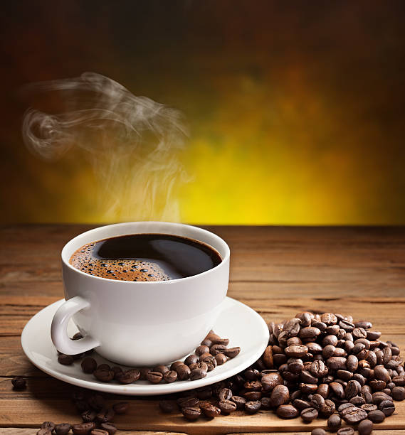 istock Cup of coffee with coffee beans on old wooden table. 486379287