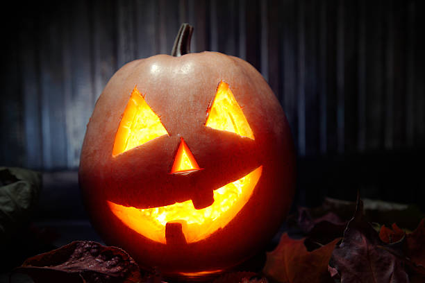 istock Jack o lanterns  Halloween pumpkin face on wooden background 486381184