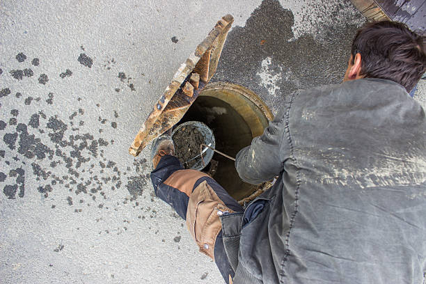 istock cleaning the sewers, blocked drain cleaning 486381557