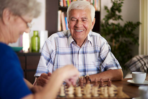 istock Marriage playing chess in the living room 486383342
