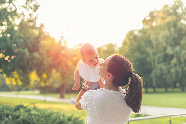 istock mother with baby in the park 486386968