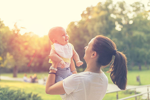 istock mother with baby in the park 486386976