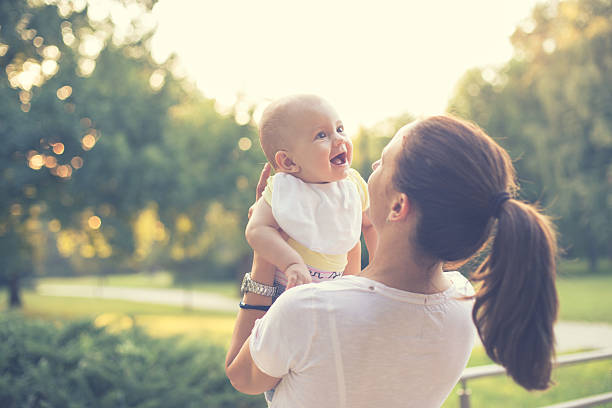 istock mother with baby in the park 486386978