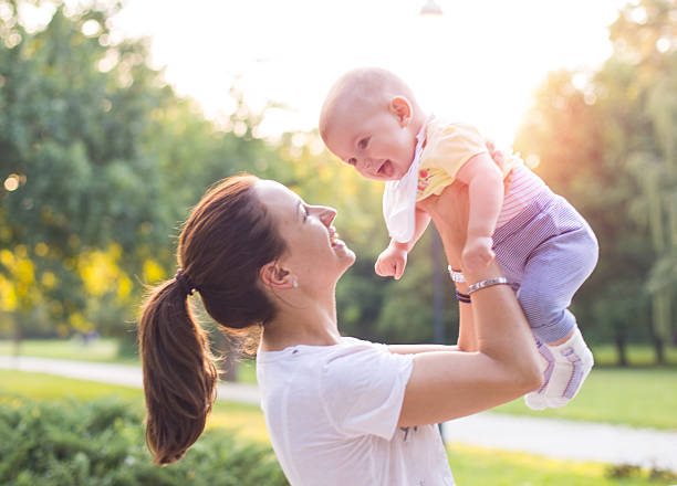 istock mother with baby in the park 486387022