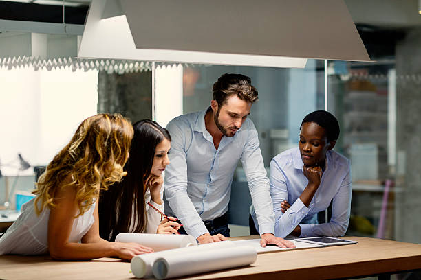istock Multiethnic Team of architects reviewing reports in the office. 486387656