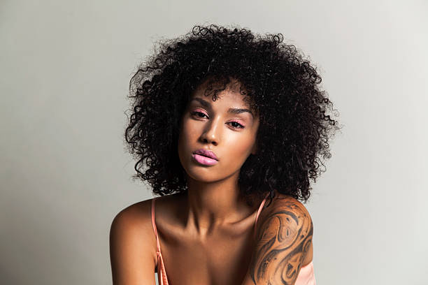 Ethnic beauty with pink eye shadow Beautiful black woman with pink eye shadow and pink lips black tattoo stock pictures, royalty-free photos & images