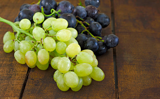 istock Assortment of grapes on a rustic wooden table 486391096