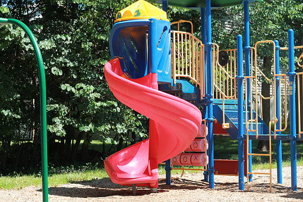 istock Kids playground with mulch and red slide 486391206