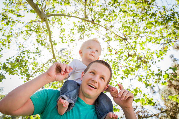 istock Cute Young Boy Rides Piggyback On His Dads Shoulders 486391883