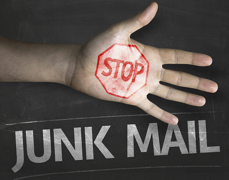 Educational and Creative composition with the message Stop Junk Mail on the blackboard