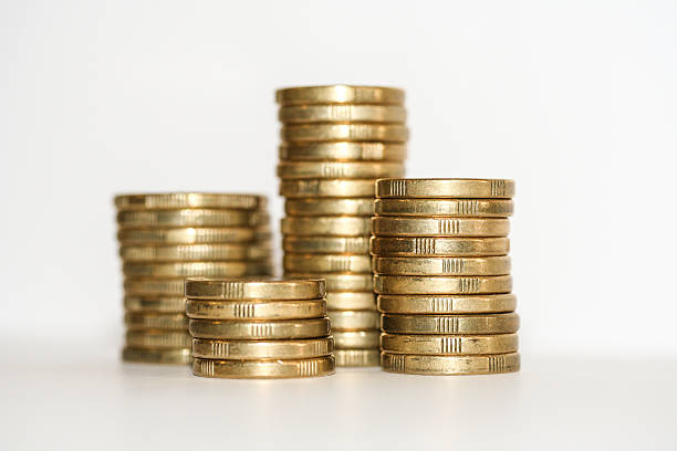 Towers of gold one and two dollar coins. stock photo