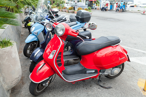 Gaeta, Italy - August 15, 2015: Classic Vespa scooters stands parked on a roadside, side view