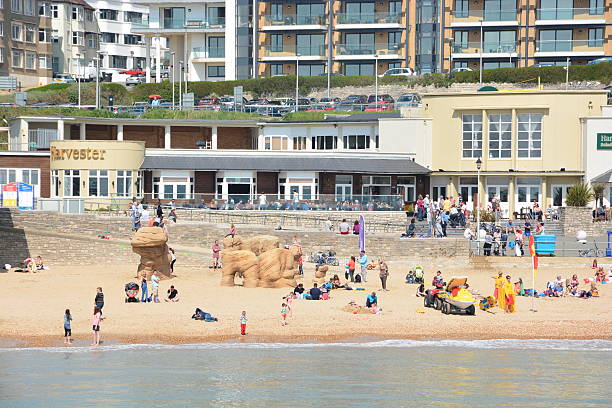 Boscombe Sea Front Bournemouth, UK - April 21, 2014: Climbing equipment and activities at Boscombe sea front in Bournemouth. People of varous ages on the beach, swimming, sunbathing and walking. boscombe photos stock pictures, royalty-free photos & images