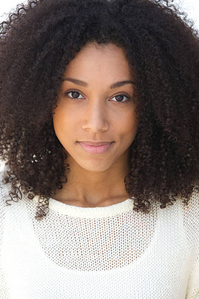 istock Young woman with curly hair grinning 486392075