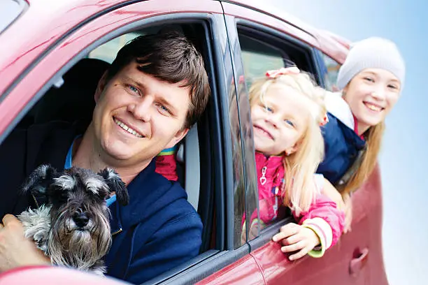 Photo of Family with a dog in the car