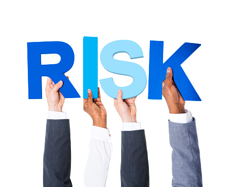 Multiethnic Business People Holding the Word Forming Risk