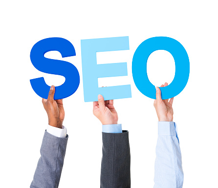 Multiethnic Business People Holding the Word Forming SEO