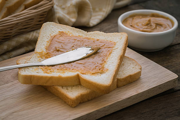 istock Peanut butter sandwich on wooden board 486396196