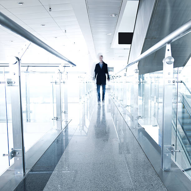 istock Blurred businessman walking down a hallway 486396211