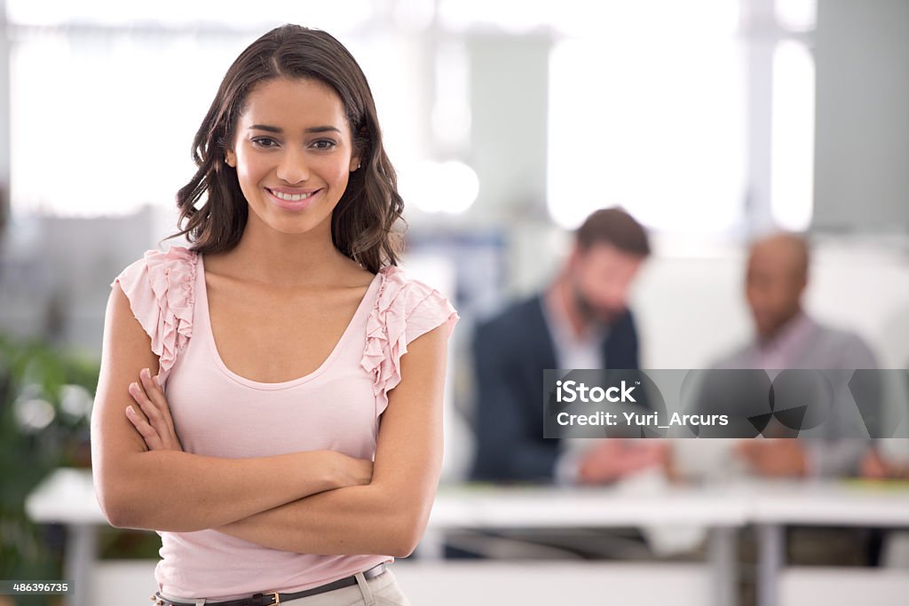 Hard work and passion = success Cropped shot of a young businesswoman with her colleagues working in the backgroundhttp://195.154.178.81/DATA/i_collage/pi/shoots/783265.jpg Businesswoman Stock Photo