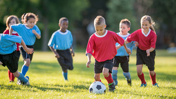 istock Boy Kicking a Soccer Ball 486400970