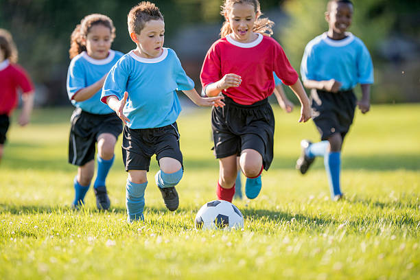 istock Children Rush to Soccer Ball 486400996