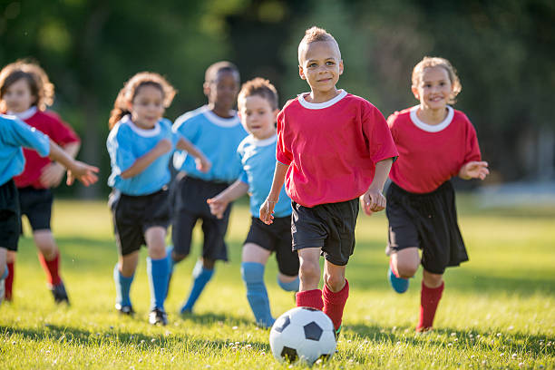 istock Little Boy Dribbling a Soccer Ball 486401020