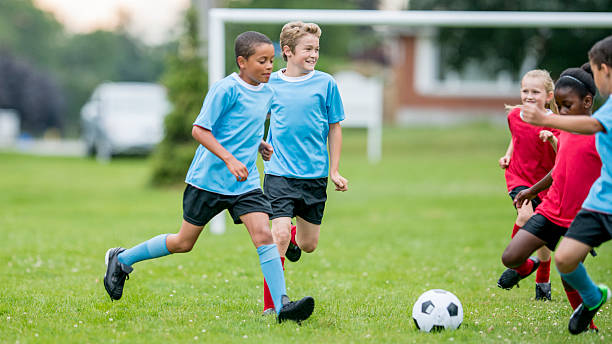 istock Kids Chasing Ball During Soccer Game 486401396
