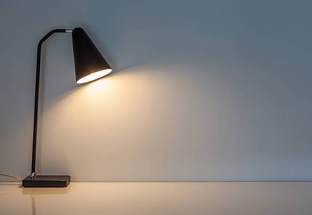 istock The modern desk lamp illuminate on the wall background. 486406268