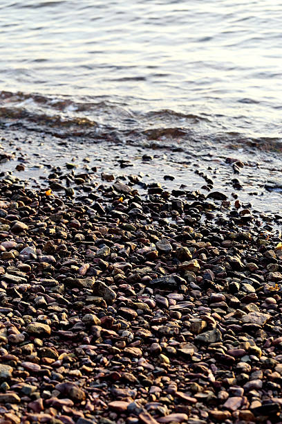 istock Sea pebble - gravel beach in sunlight, selective focus. 486408224