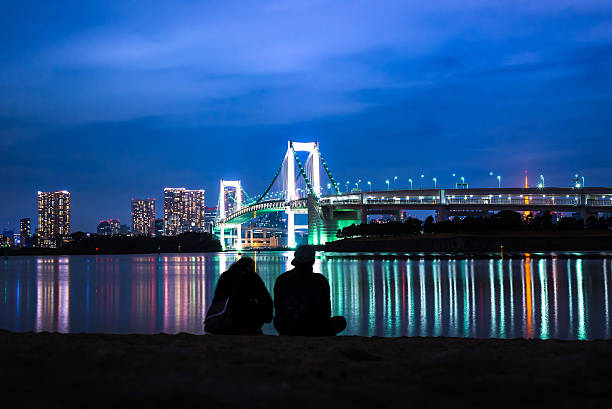 Light of Rainbow bridge at night and Tokyo tower stock photo