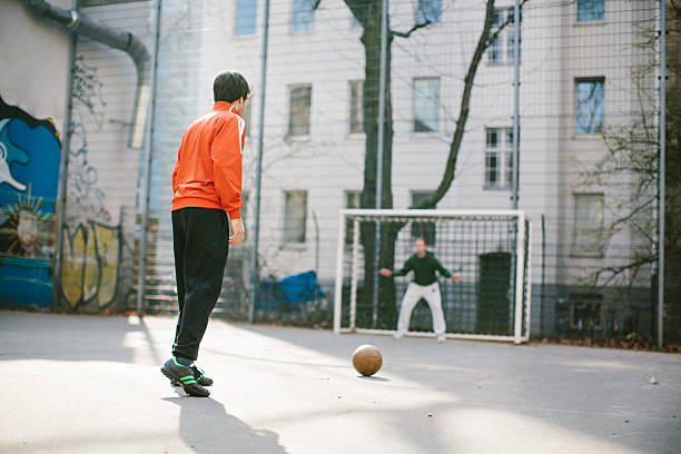 Young men playing soccer in the city