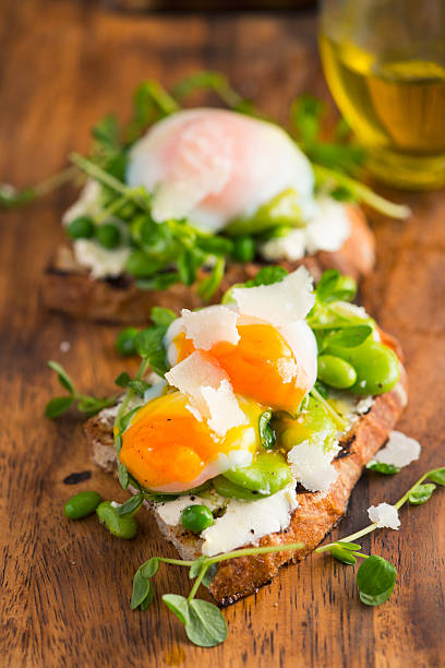 istock Bruschetta with Cream Cheese, Beans and Pea Sprout and Poached Egg 486415358
