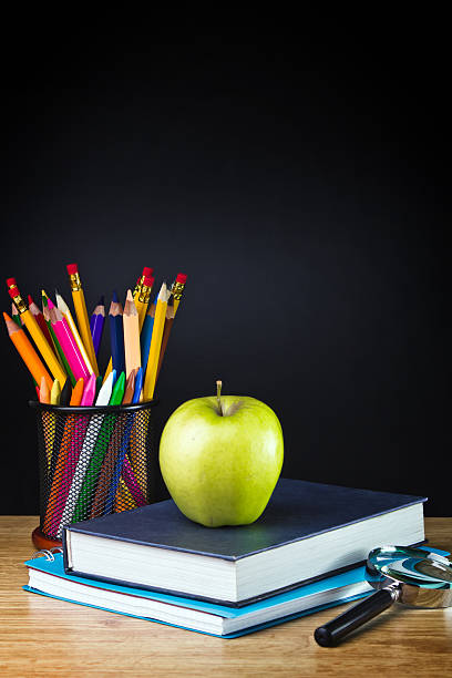 istock Teacher's desk with a color pencil, notebook and other equipment. 486415793
