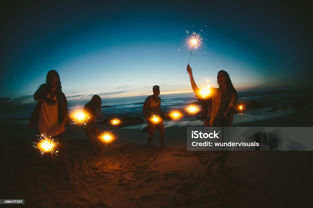 Group of friends with fireworks Beach Stock Photo