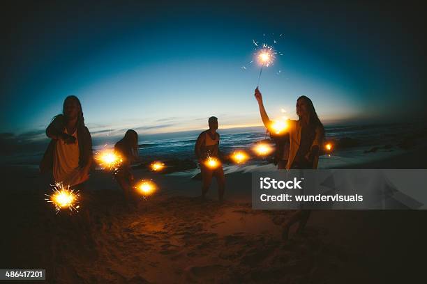 Group Of Friends With Fireworks Stock Photo - Download Image Now - Beach, Sparkler - Firework, Water's Edge