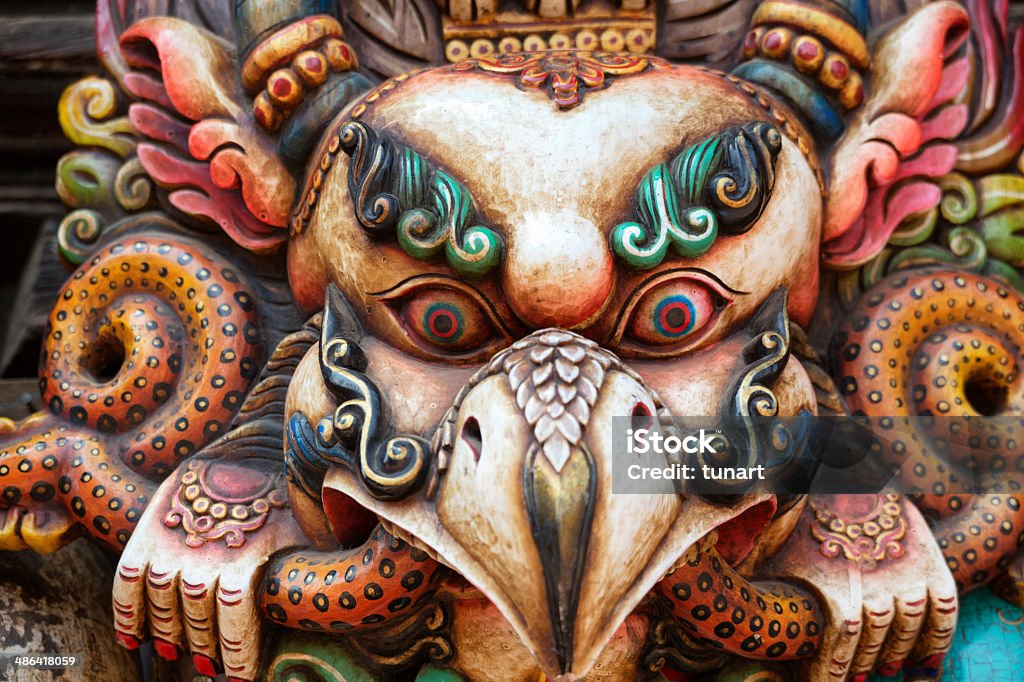Traditional Mask of Garuda The Garuda is a large mythical bird, bird-like creature, or humanoid bird that appears in both Hindu and Buddhist mythology.  Animal Stock Photo