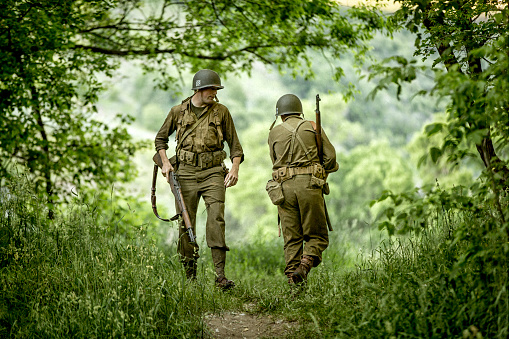 Stock photo of two models dressed as an World War II Army soldiers in an forrest.